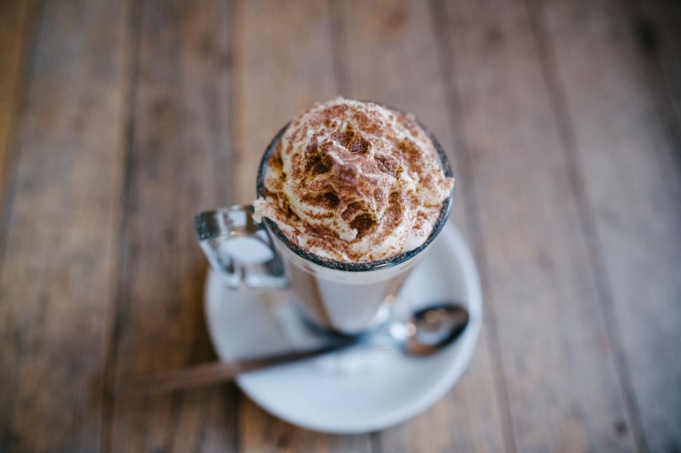 Free Image of A cup of coffee with whipped cream and a spoon 