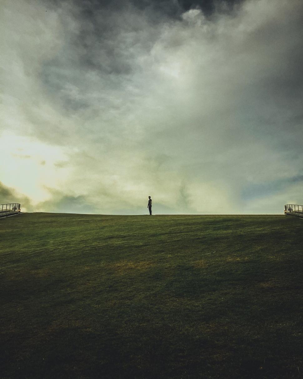 Free Image of A person standing on a hill 