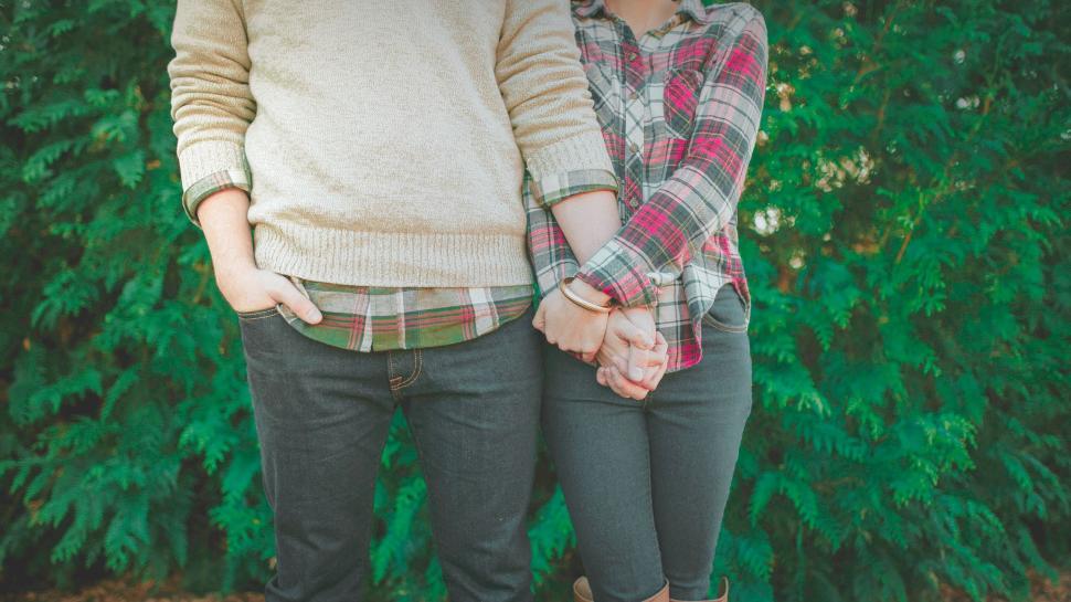 Free Image of A man and woman holding hands 