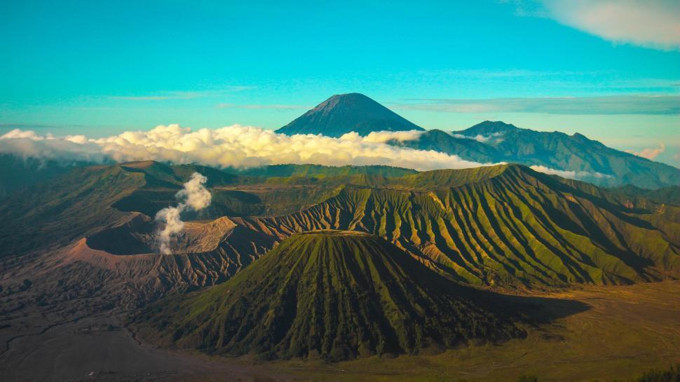 Free Image of Mount bromo range with clouds and blue sky 