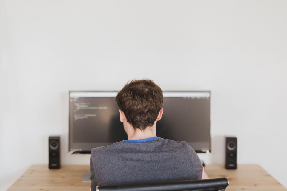 Free Image of A man sitting in front of a computer 