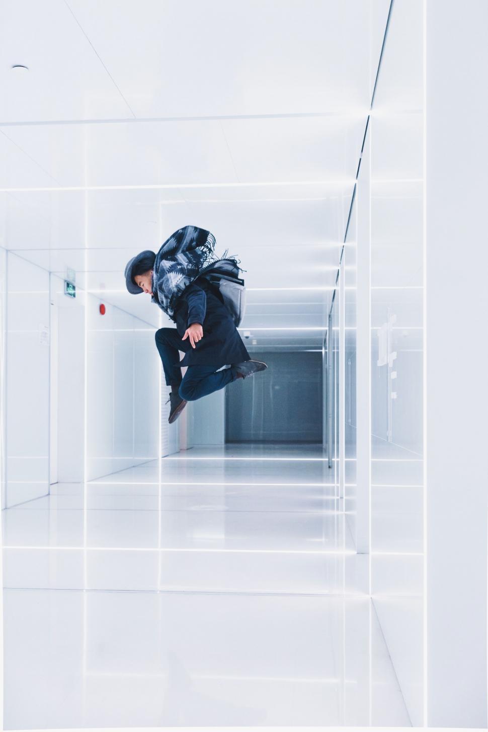 Free Image of A man jumping in a hallway 