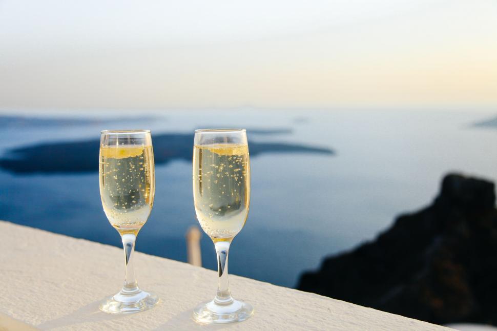 Free Image of Two glasses of champagne on a ledge 