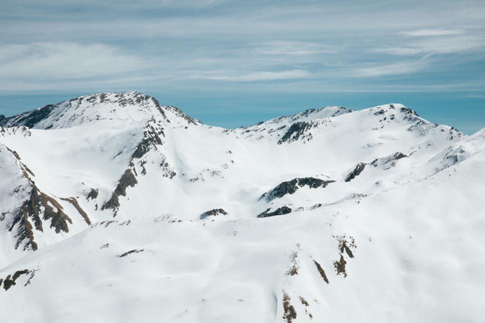 Free Image of A snowy mountain tops with blue sky 
