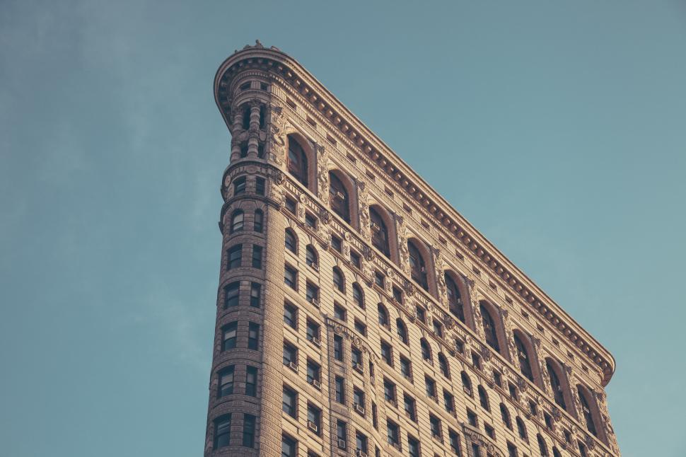 Free Image of A tall building with many windows with flatiron building in the background 