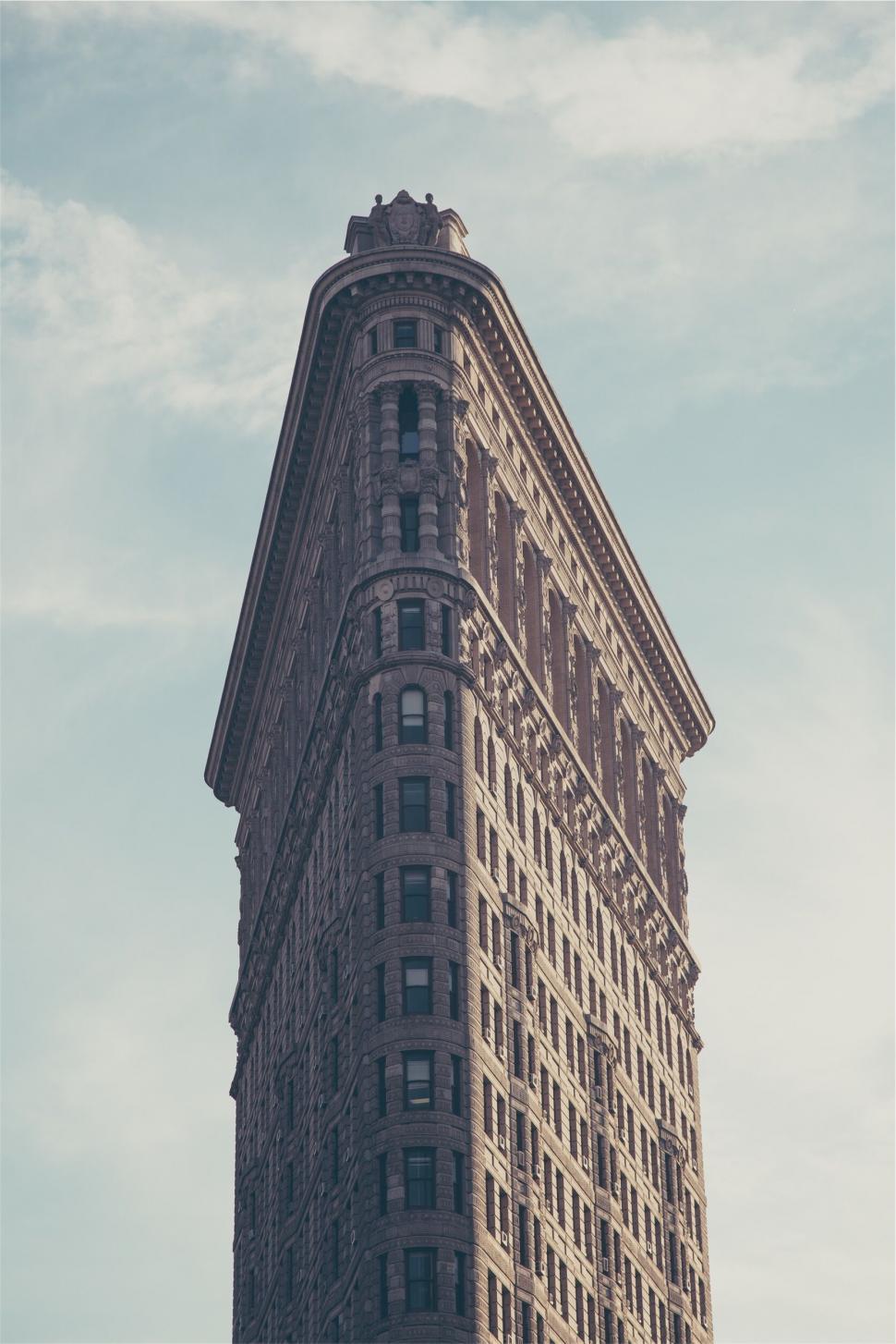 Free Image of A tall building with a spire with flatiron building in the background 