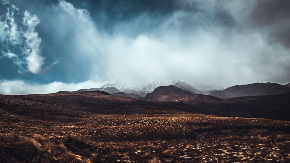 Free Image of Cloudy Sky Over Mountain Range in Desert 