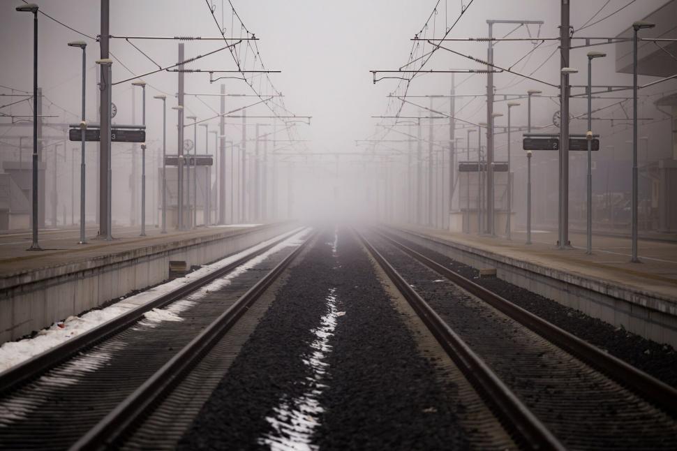 Free Image of A train tracks in a foggy day 