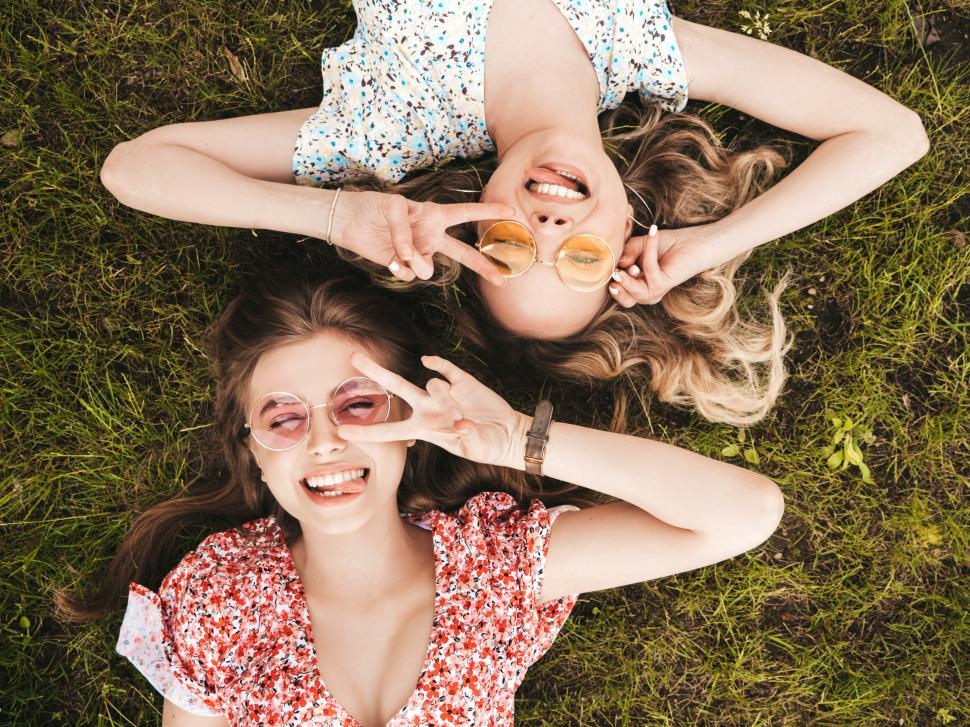 Free Image of Two women lying in the grass 