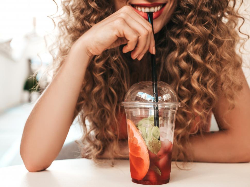 Free Image of A woman drinking from a straw 