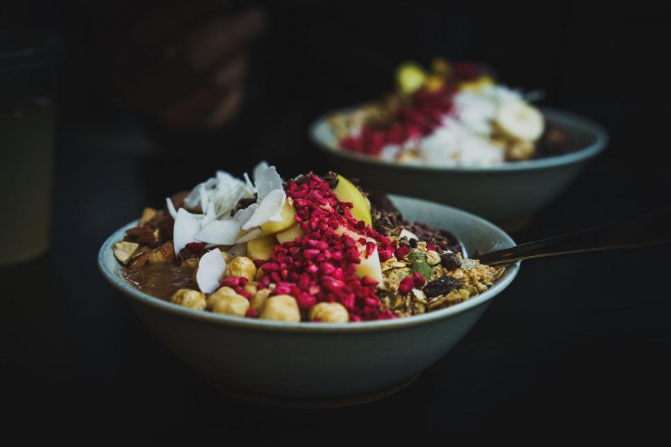Free Image of A bowl of cereal with fruit and nuts 