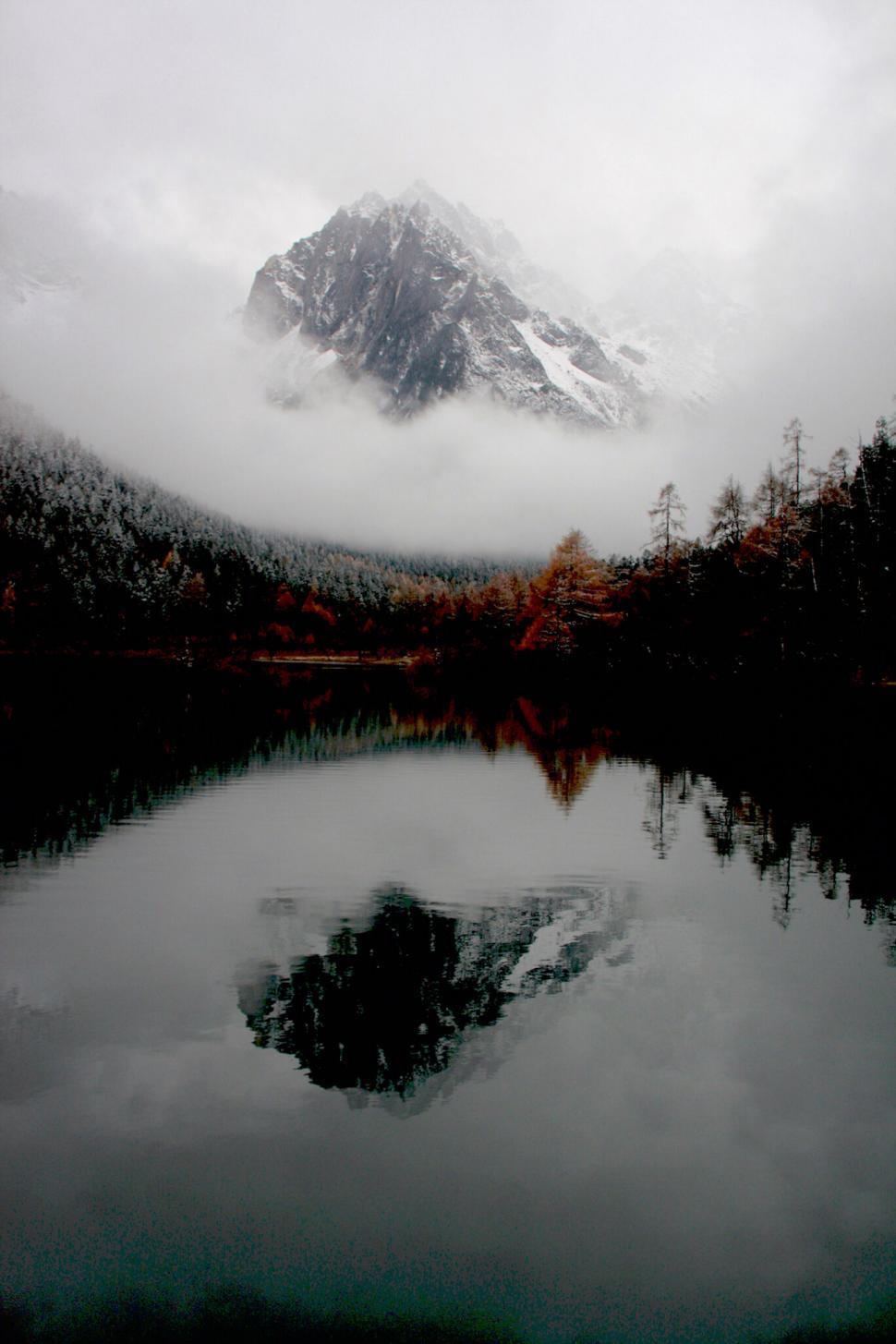 Free Image of A lake with a mountain in the background 