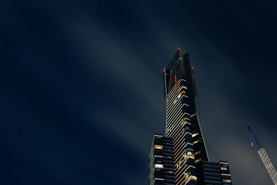 Free Image of A tall building with lights on 