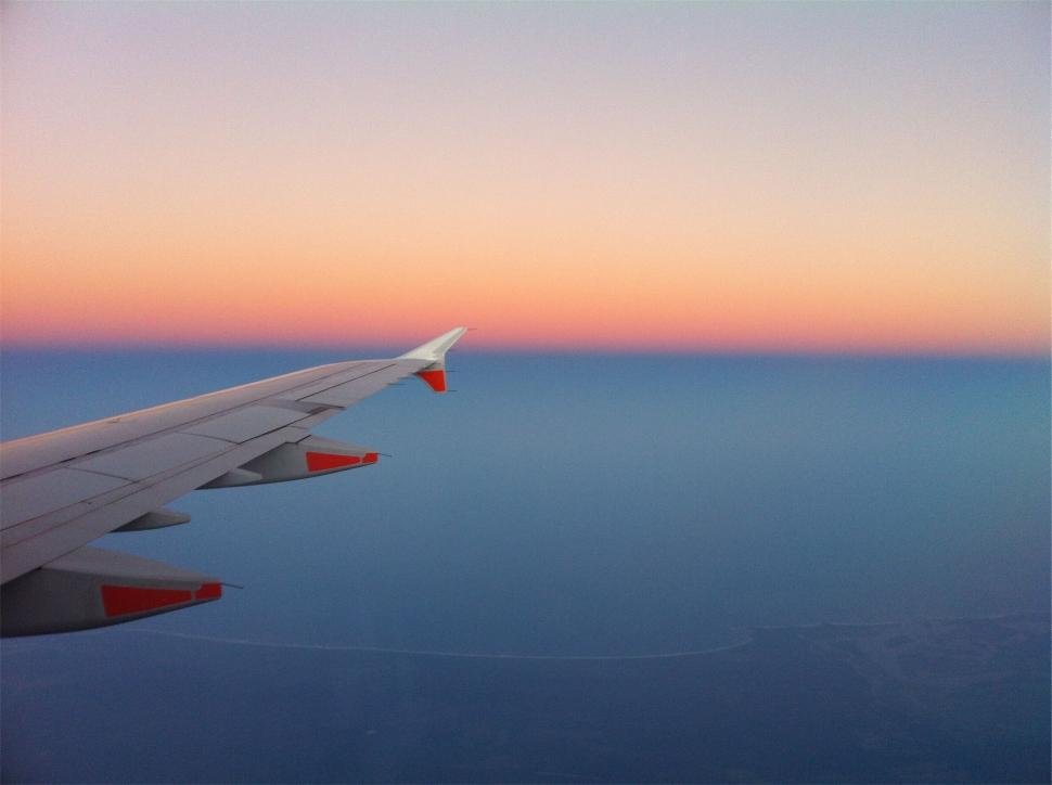 Free Image of An airplane wing above the ocean 