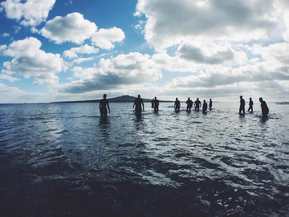 Free Image of A group of people standing in water 