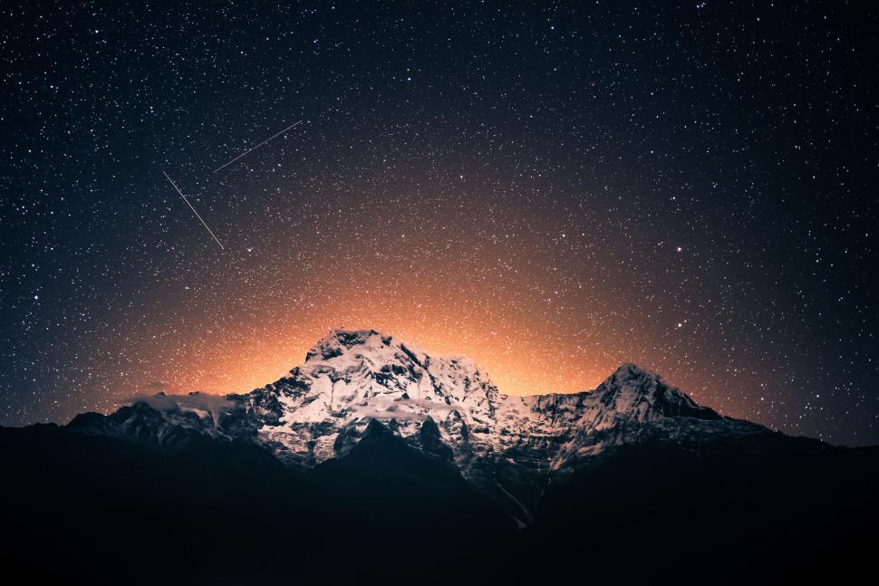 Free Image of A snowy mountain with stars in the sky 