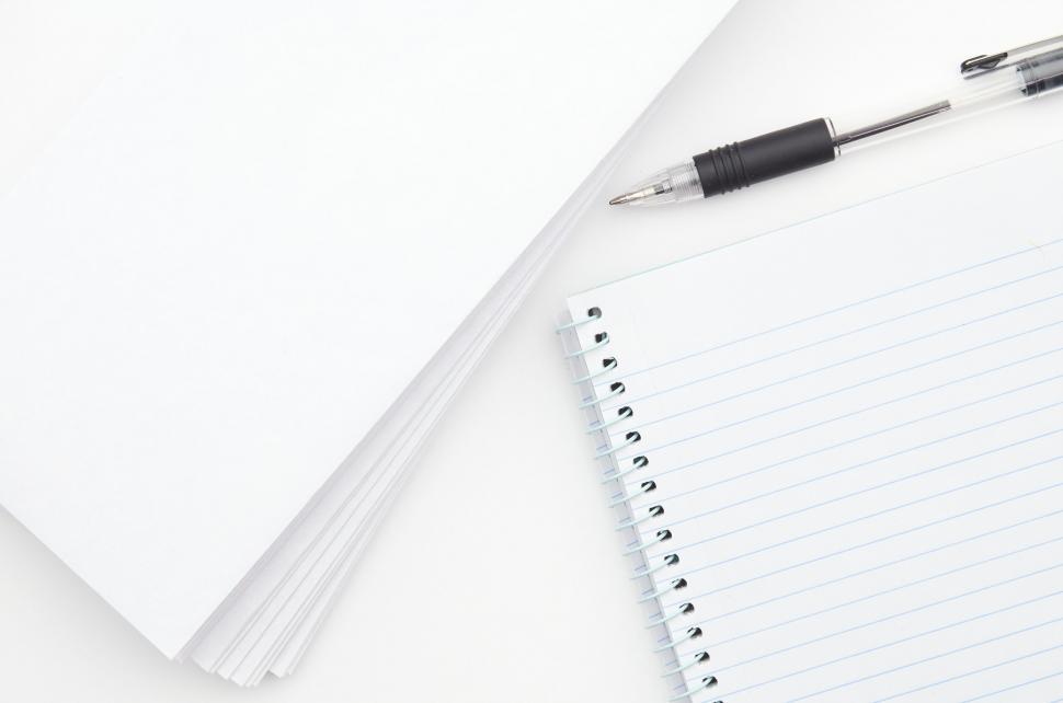 Free Image of A spiral notebook and a pen 