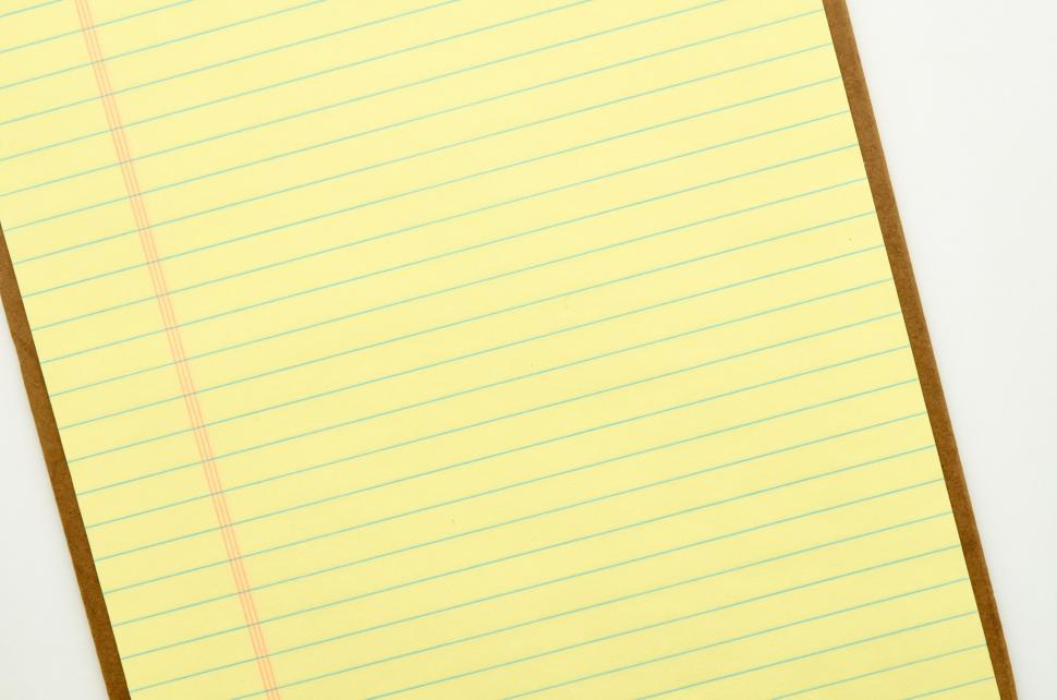 Free Image of A yellow lined paper with blue lines 