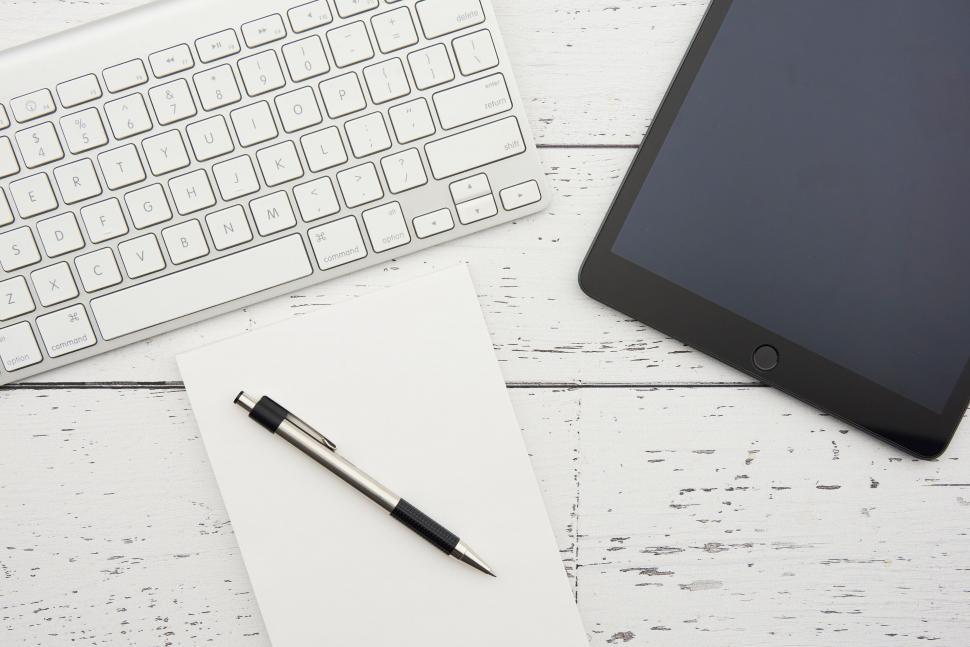 Free Image of A tablet and a pen on a white surface 