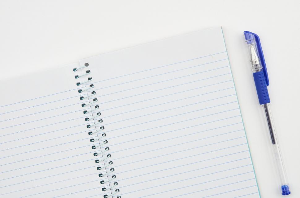 Free Image of A notebook and pen on a white surface 