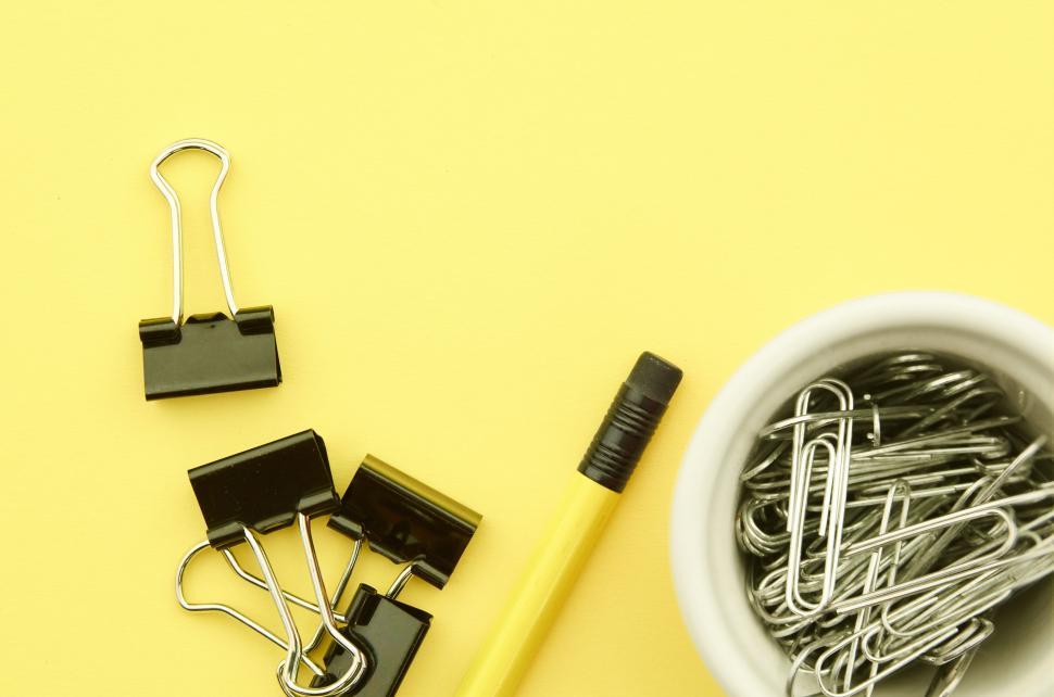 Free Image of A pencil and paper clips 