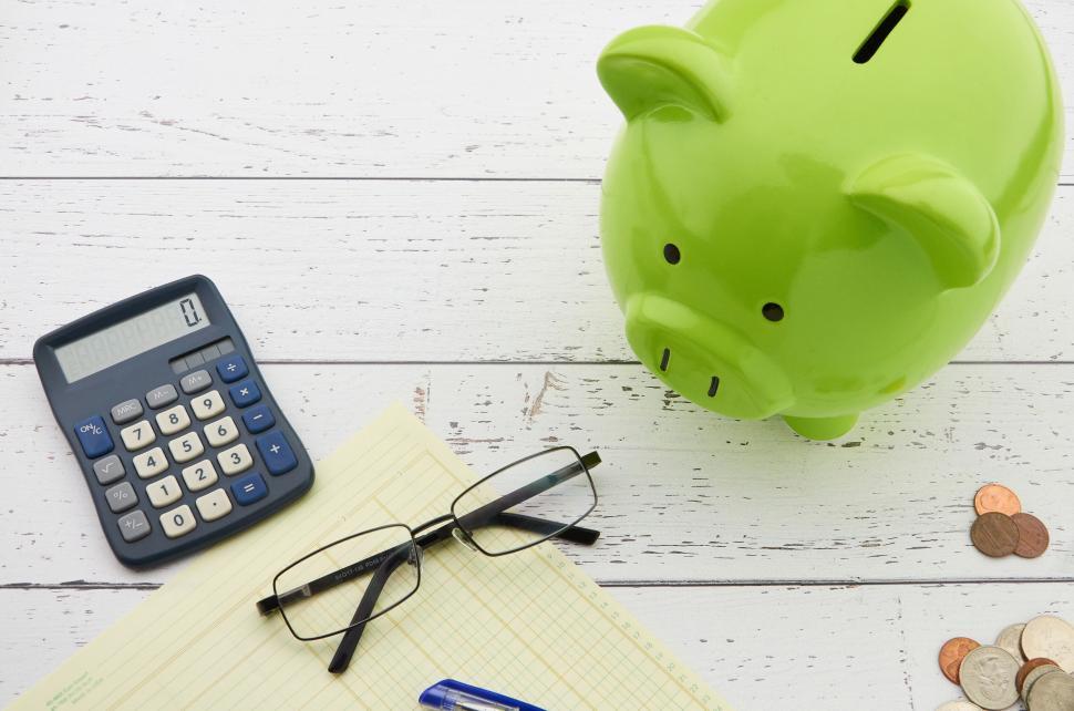 Free Image of A green piggy bank and calculator 