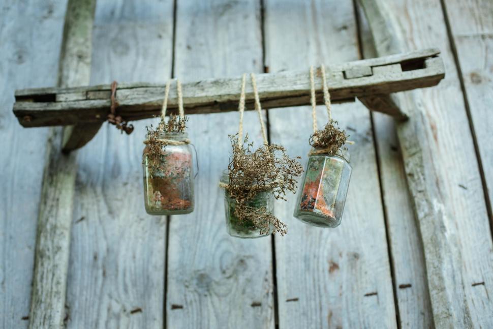 Free Image of A group of glass jars from a wooden ladder 