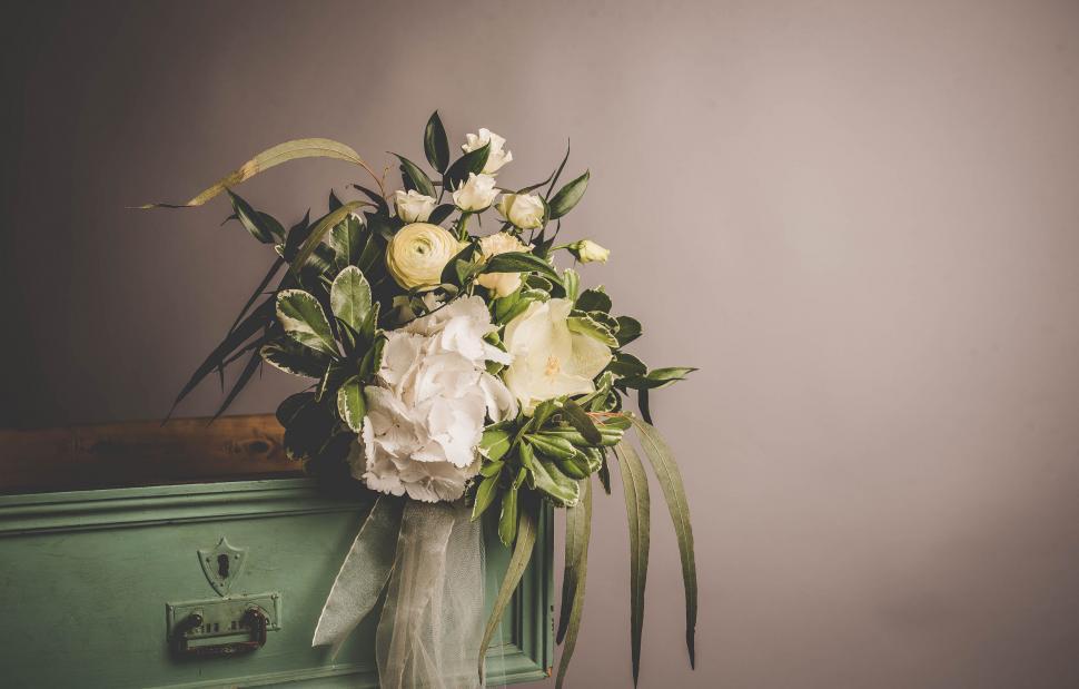 Free Image of A bouquet of flowers on a dresser 