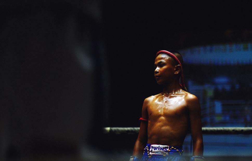 Free Image of A young boy in a boxing ring 