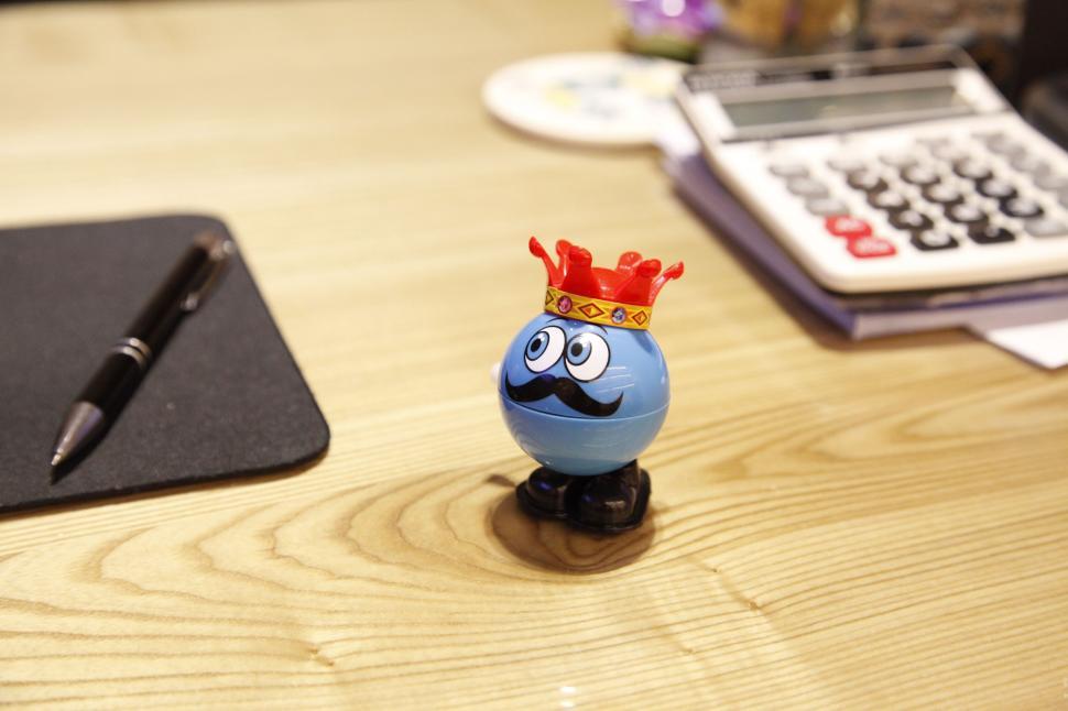 Free Image of A blue toy with a mustache and crown on a table 