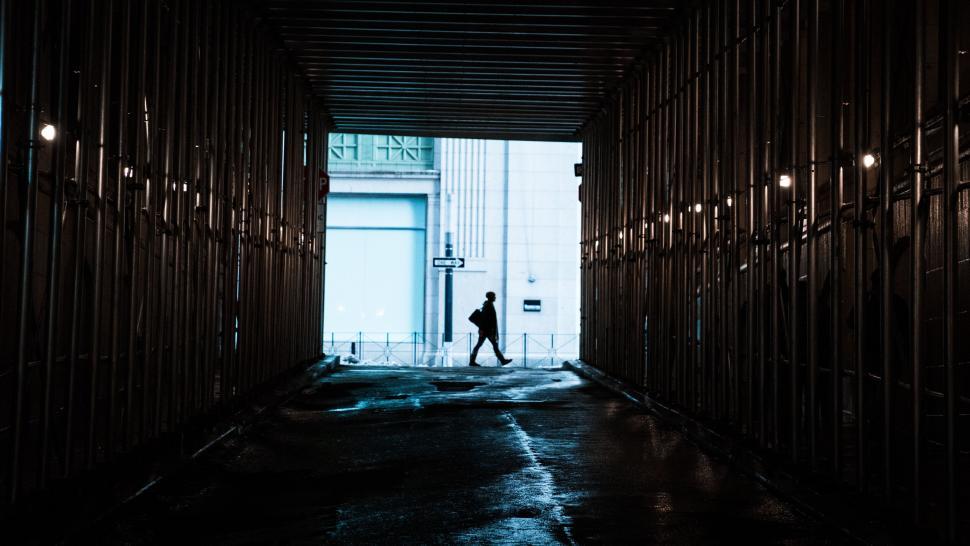 Free Image of A person walking in a tunnel 