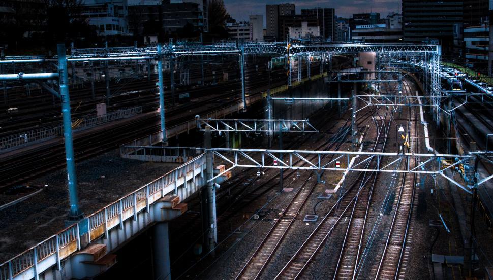Free Image of A train tracks with a city in the background 