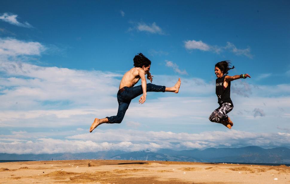 Free Image of Two people jumping in the air 