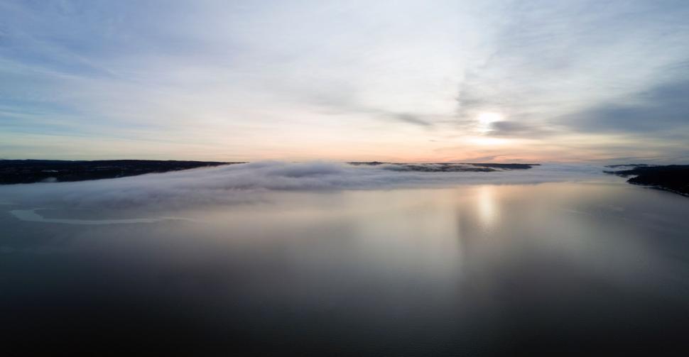 Free Image of A body of water with clouds above it 