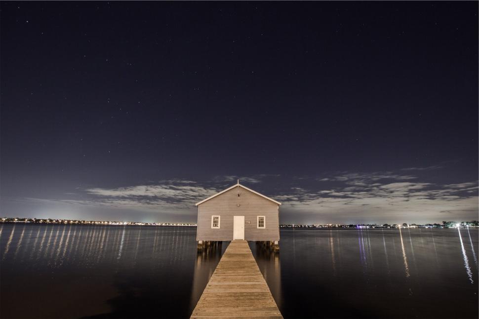Free Image of A house on a dock over water 