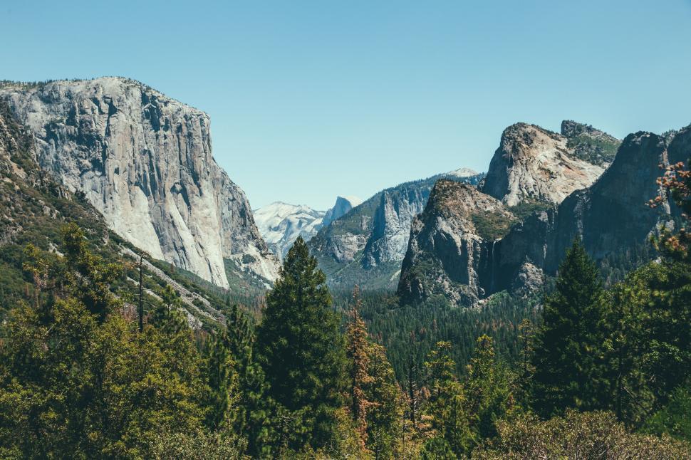 Free Image of A mountain range with trees and a valley 