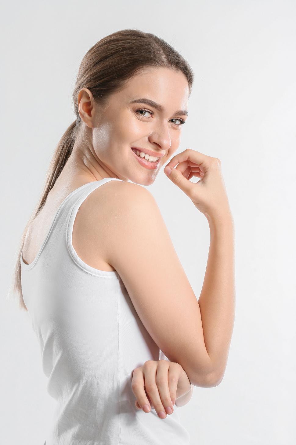 Free Image of A woman in a white tank top 