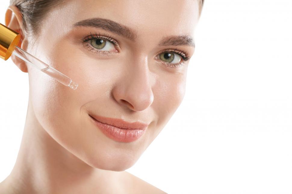 Free Image of A woman with a dropper on her face 