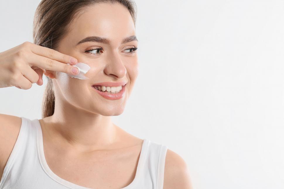 Free Image of A woman applying a face cream 