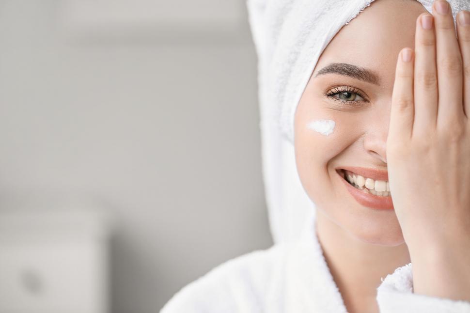 Free Image of A woman with a towel on her head smiling 