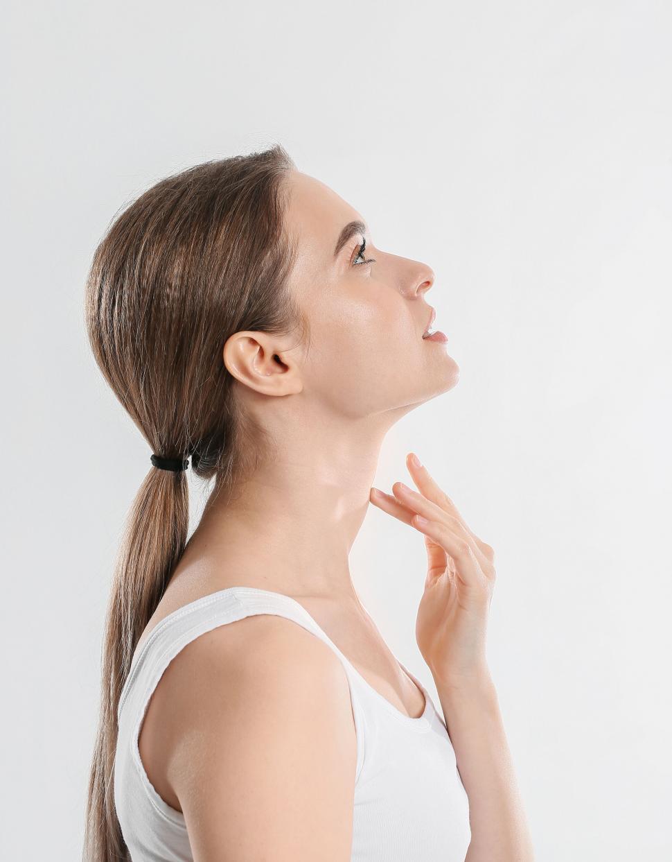 Free Image of A woman with her hand on her chin 