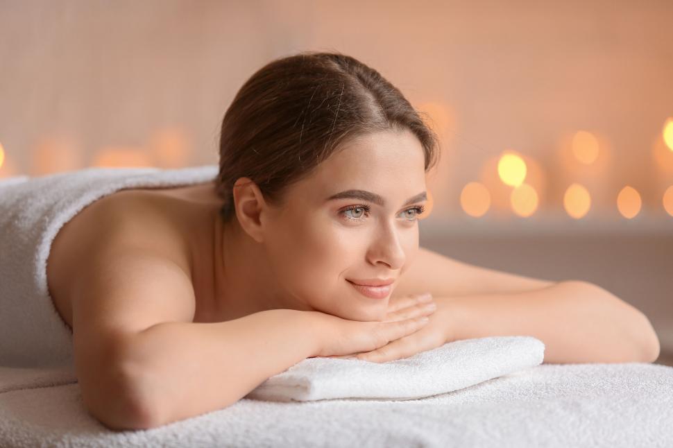 Free Image of A woman lying on a towel 