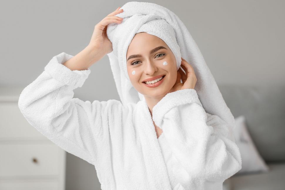 Free Image of A woman in a bathrobe and a towel on her head 