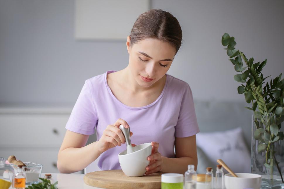 Free Image of A woman using a mortar and pestle 