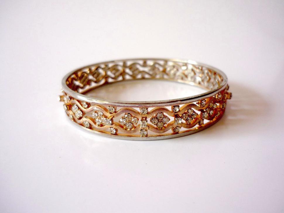 Free Image of Two Gold Rings With Diamonds on White Surface 
