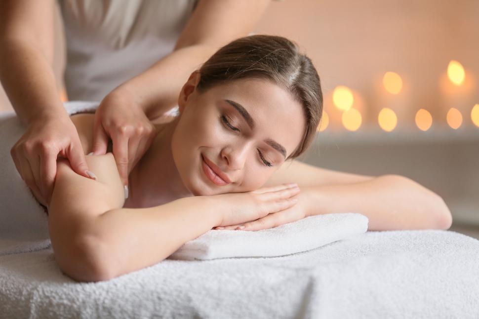 Free Image of A woman lying down on a massage table 