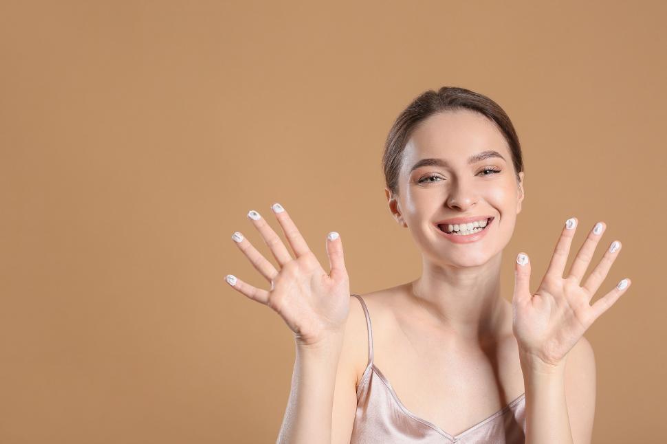 Free Image of A woman smiling with her hands up 