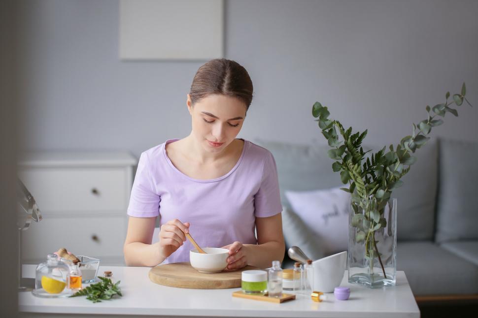 Free Image of A woman sitting at a table with a bowl of food 