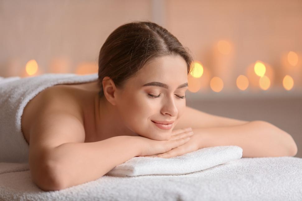 Free Image of A woman lying on a white towel 
