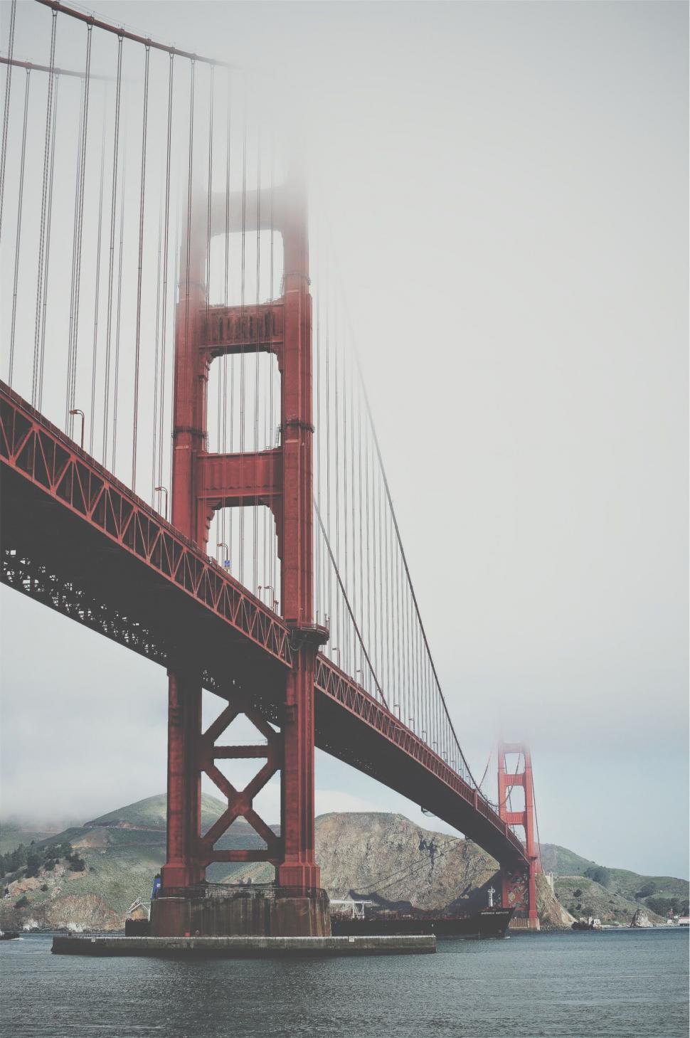 Free Image of Golden gate bridge with a body of water and mountains 
